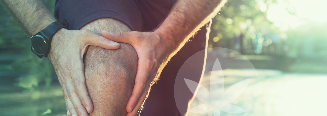 a man holding his knee because of pain